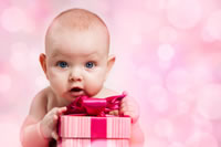 baby holding a pink box