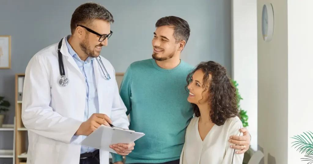 Hysteroscopy procedure consultation with a smiling couple and doctor in a bright medical office