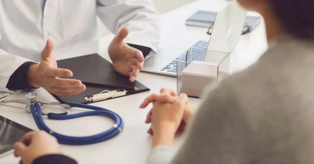 First IVF treatment consultation with patient and doctor discussing results at a medical desk.