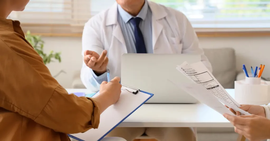 Invocell for infertility discussed as a couple reviews medical documents with a fertility specialist at a desk.