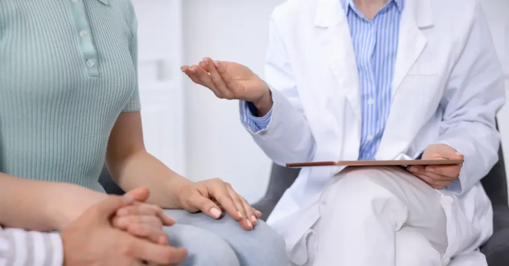 Traditional IVF process explained by a doctor during a fertility consultation with a couple.