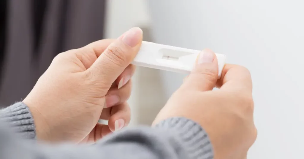 Surgical options for infertility implied as a person examines a faint result on a pregnancy test.