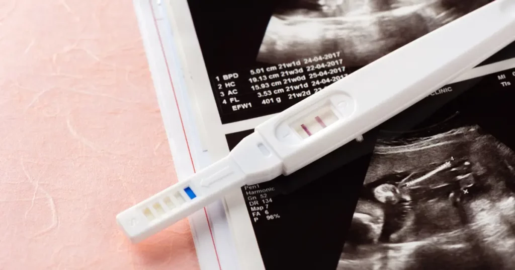 Fertility preservation options shown by a positive pregnancy test resting on ultrasound images.